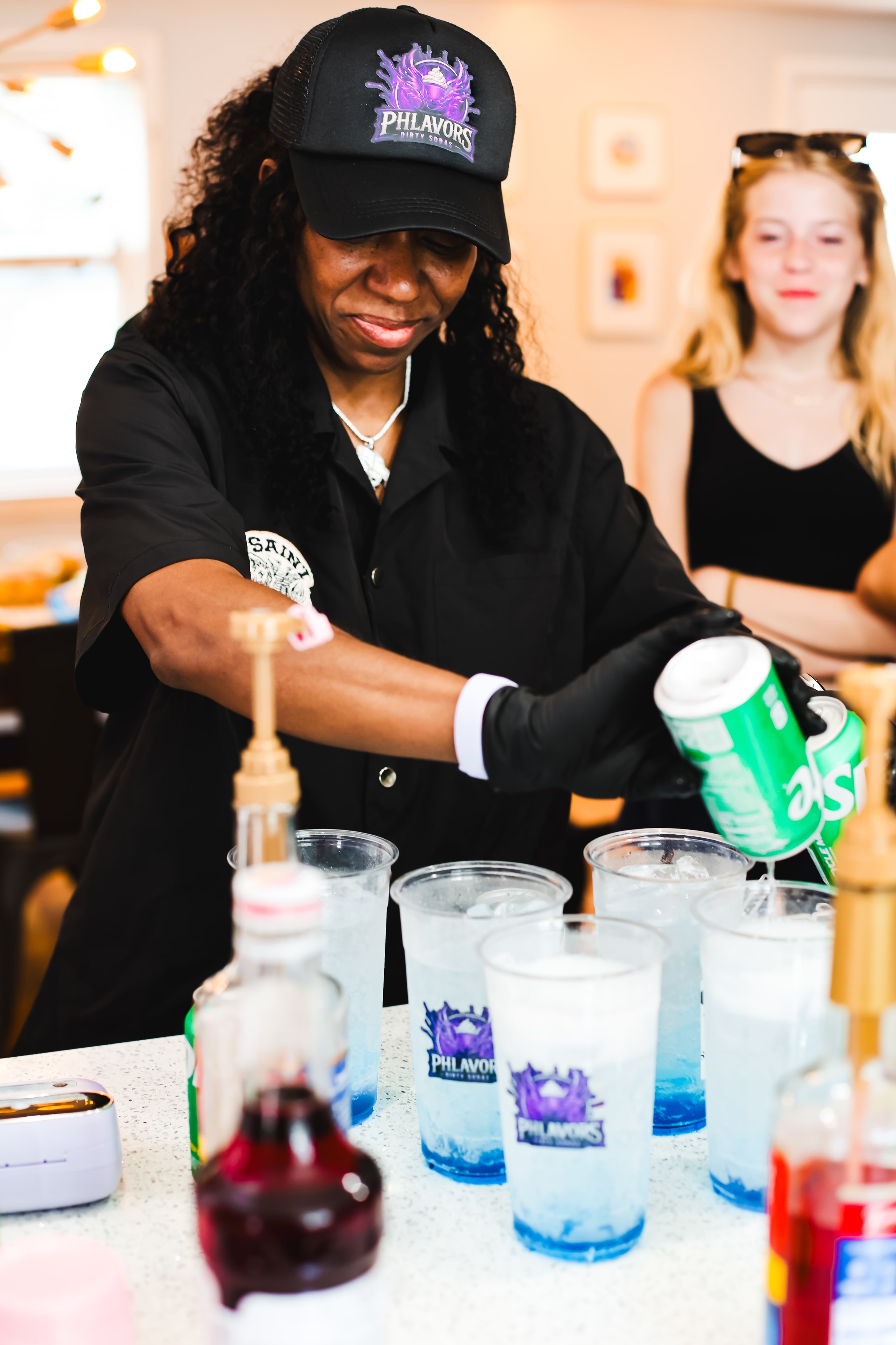 Phlavors owner pouring Sprite into branded cups