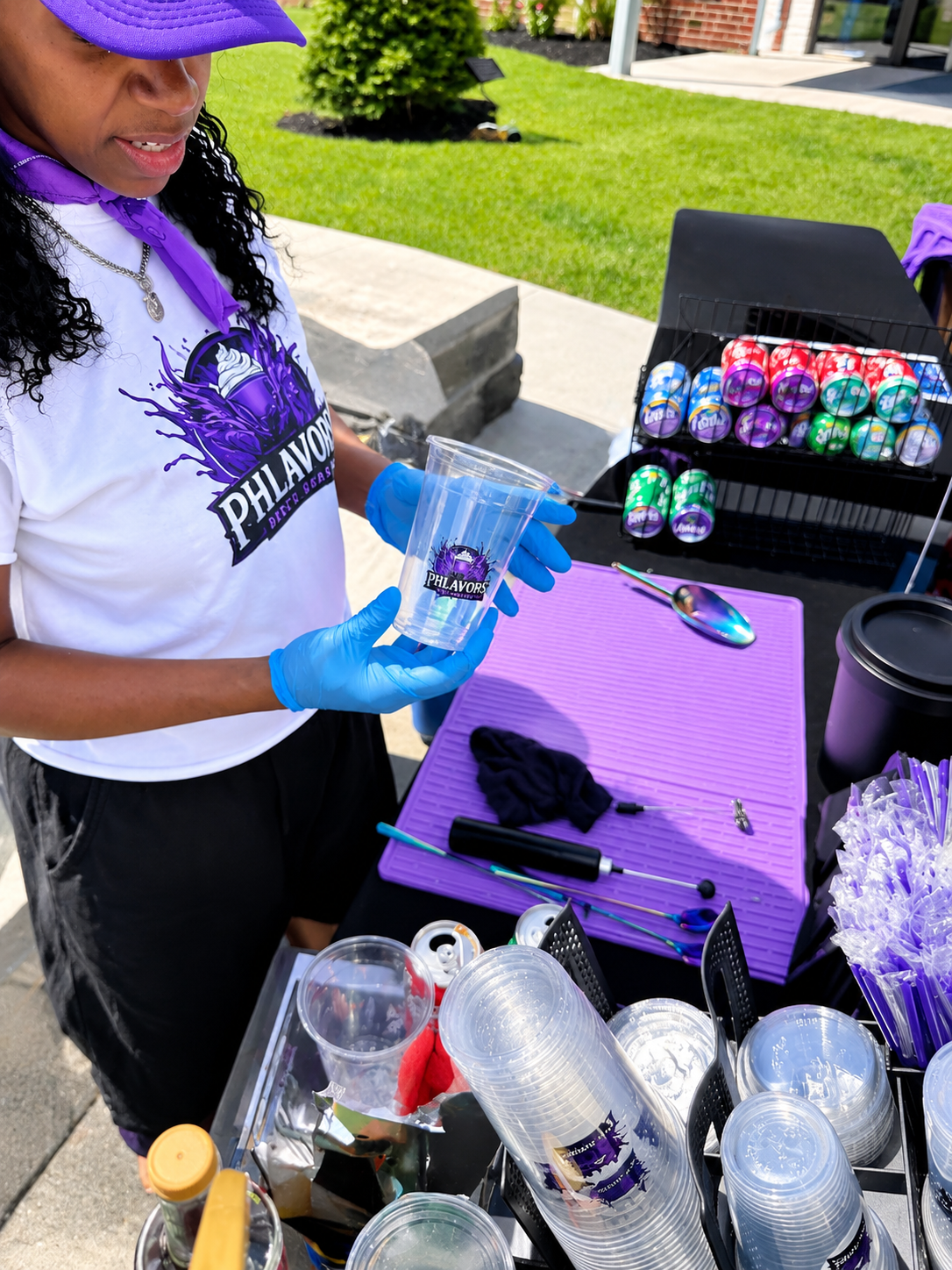 Phlavors owner preparing branded cups at an outdoor pop-up event