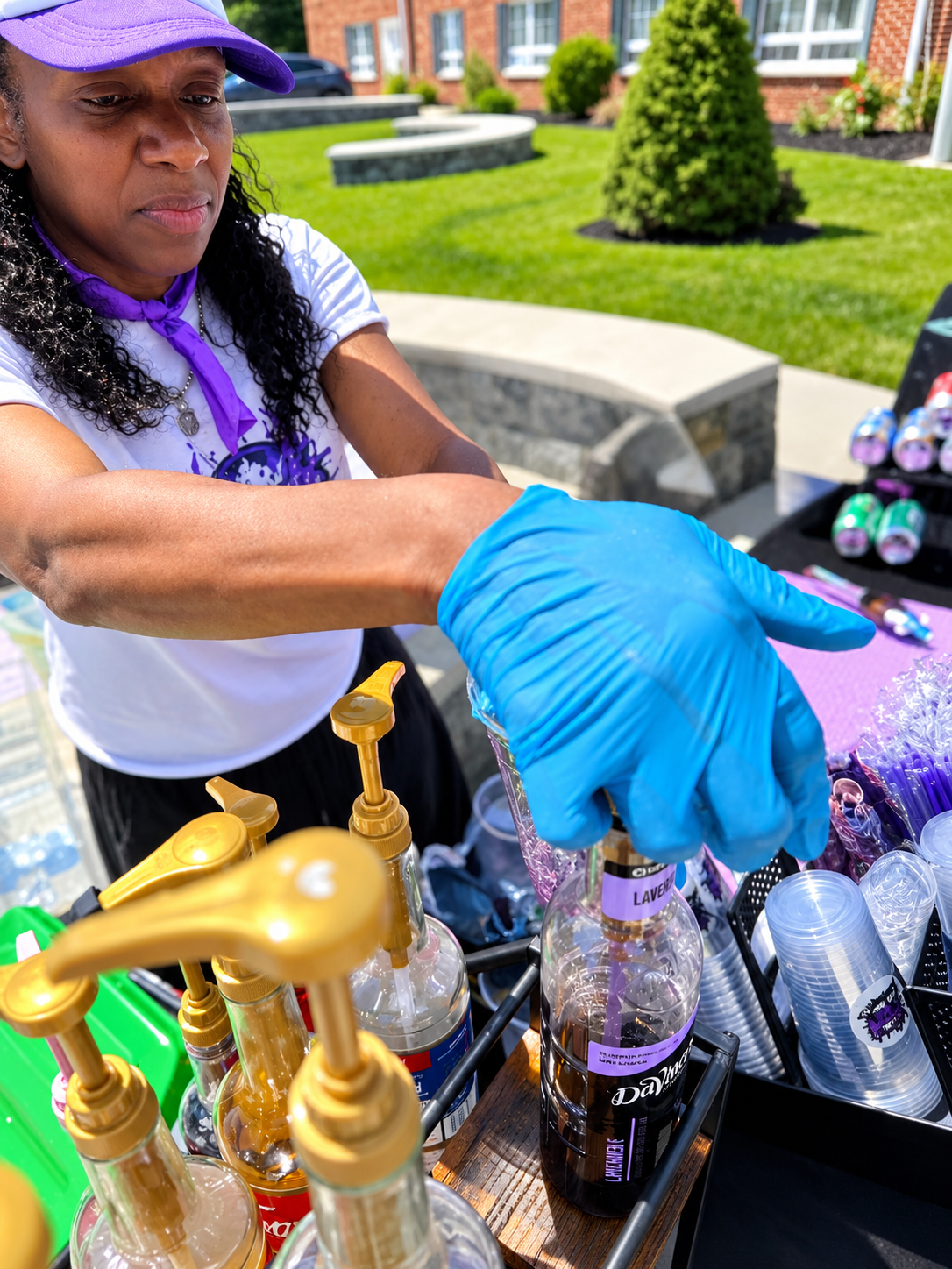 Phlavors owner working the syrup station at an outdoor event